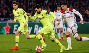 Barcelona's Lionel Messi is pursued by Houssem Aouar just before the Lyons player's challenge sends the ball back to Messi.