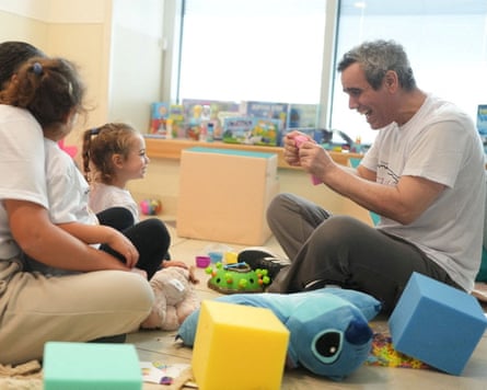 Omri Miran plays with his daughter after being released