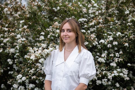 Diana Reid standing in front of a flowering bush