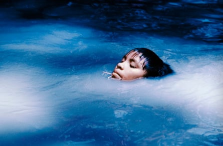 A Yanomami person lying in water