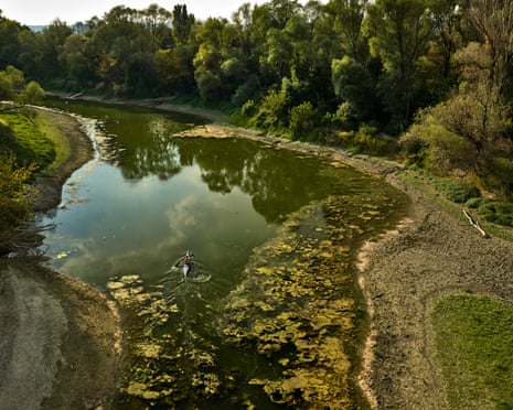A shallow channel of water separates two banks of the river