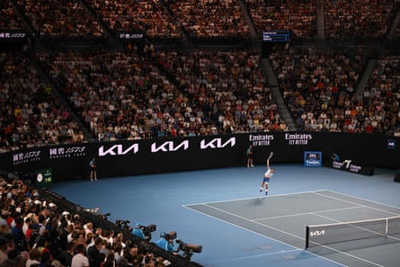 Novak Djokovic serves against Andrey Rublev in a packed Rod Laver Arena