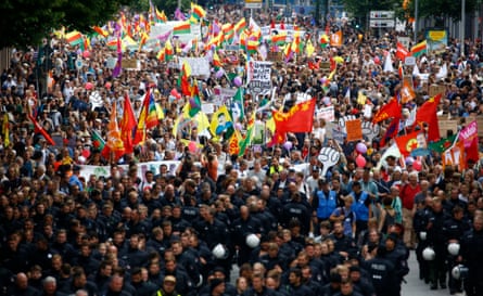 Police walk ahead of protesters demonstrating against the G20 summit in Hamburg
