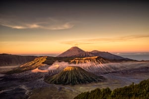 Tengger volcanic complex, IndonesiaThis is part of a national park on the Indonesian island of Java that lies within a large caldera – the remains of an volcano that erupted more than 45,000 years ago. In this view, the volcanic cones comprising the Tengger complex are at the centre, with smoke coming from Mount Bromo. In the distance is Mount Semeru.