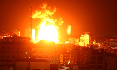 Fire and smoke rise above buildings in Gaza City after Israeli warplanes targeted the Palestinian enclave early on Monday.