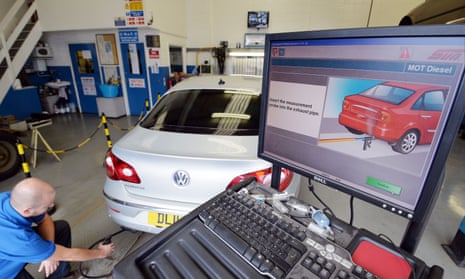 A VW Passat CC car is tested for its exhaust emissions at a testing station