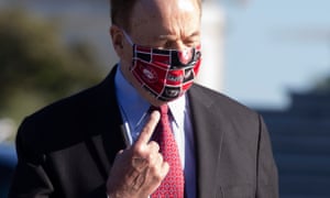 Republican Senator from Alabama Richard Shelby points to his University of Alabama face mask last month in Washington.
