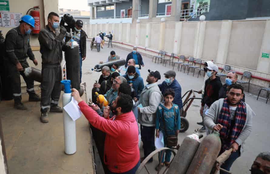 Workers collect oxygen cylinders from a Gulf Gases factory in Cairo, Egypt, 05 January 2021.