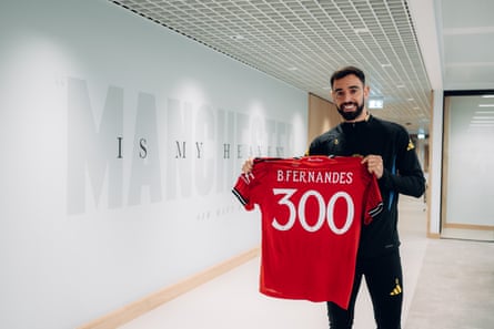 Bruno Fernandes holds a commemorative shirt ahead of his 300th appearance for Manchester United