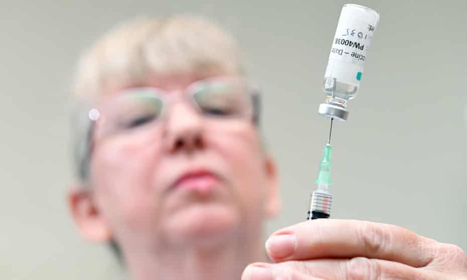 A nurse draws from a vial of Covid vaccine at the medical centre in Brisbane.
