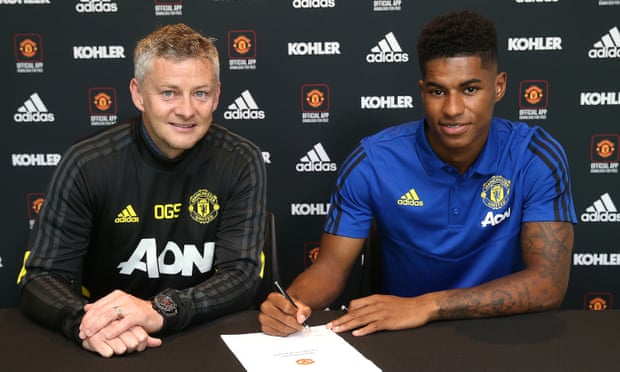 Marcus Rashford of Manchester United poses with Manager Ole Gunnar Solskjær after signing a contract extension with the club.