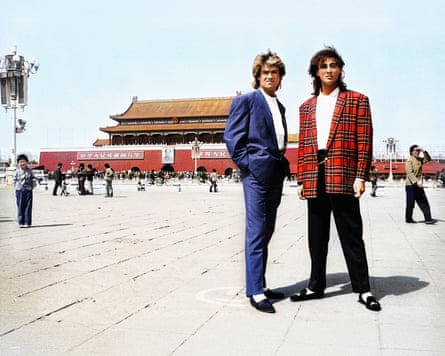 George Michael and Andrew Ridgeley standing in a square with traditional Chinese buildings behind them
