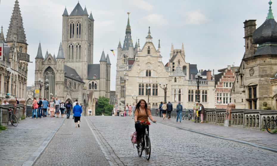 A cyclist rides through the city centre in Ghent, where three-quarters of residents are in favour of plans to expand the pedestrian zone.