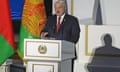 Lukashenko stands behind a podium