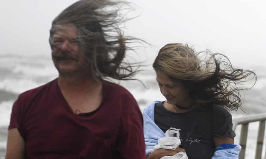 People’s hair blows in the wind ahead of Tropical Storm Nicholas on Monday in Corpus Christi, Texas.