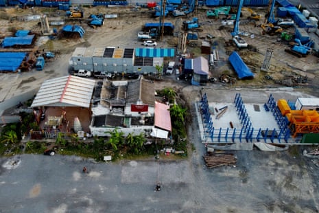 A construction site surrounds the Chao Mae Thap Thim shrine in Bangkok.
