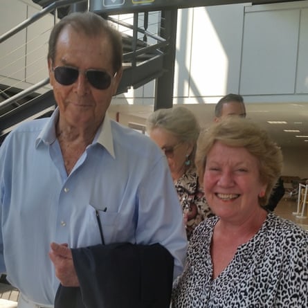‘We bumped into Roger Moore in the waiting room at Nice airport on 9th September last year. He was happy that we recognised him and gladly posed with my wife for this photo.’
