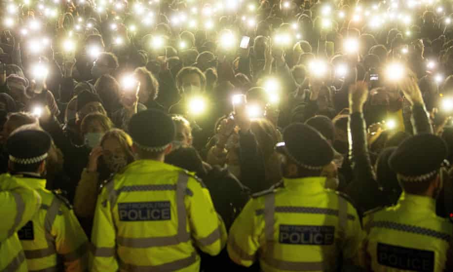 People in the crowd turning on their phone torches in Clapham Common, London, at a vigil for Sarah Everard. 