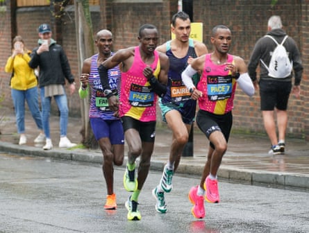 Emile Cairess (in blue) overtakes Sir Mo Farah as they approach the Isle of Dogs in last year’s London Marathon