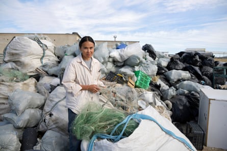 Assal Baimukanova stands among the estimated 10 tonnes of rubbish collected from the Caspian Sea over 20 days