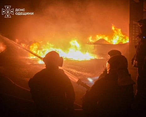 Firefighters work at the site of a warehouse hit by an overnight Russian drone strike, amid Russia's attack on Ukraine, in Odesa region.