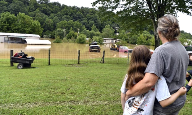Bonnie Combs, right, hugs her 10-year-old granddaughter, Adelynn Bowling, as her property becomes covered by the North Fork of the Kentucky River in Jackson.