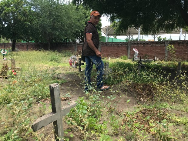 A gravedigger tours unmarked graves in the public cemetery in Tecomán, Mexico’s most murderous municipality