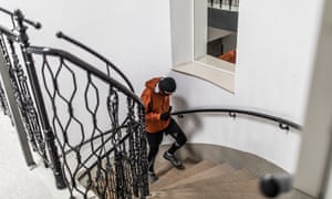 A young male athlete runs up the stairs