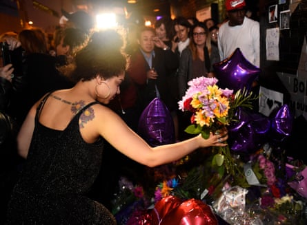 A fan leaves flowers outside First Avenue, the nightclub featured in the movie Purple Rain, in Minneapolis.