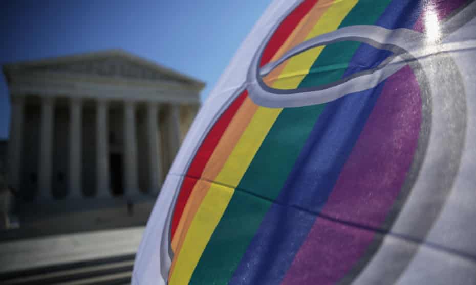 An activist flies a ‘marriage pride flag’ outside the US supreme court on 9 January 2015 in Washington DC as it deliberated on legalizing same-sex marriage.