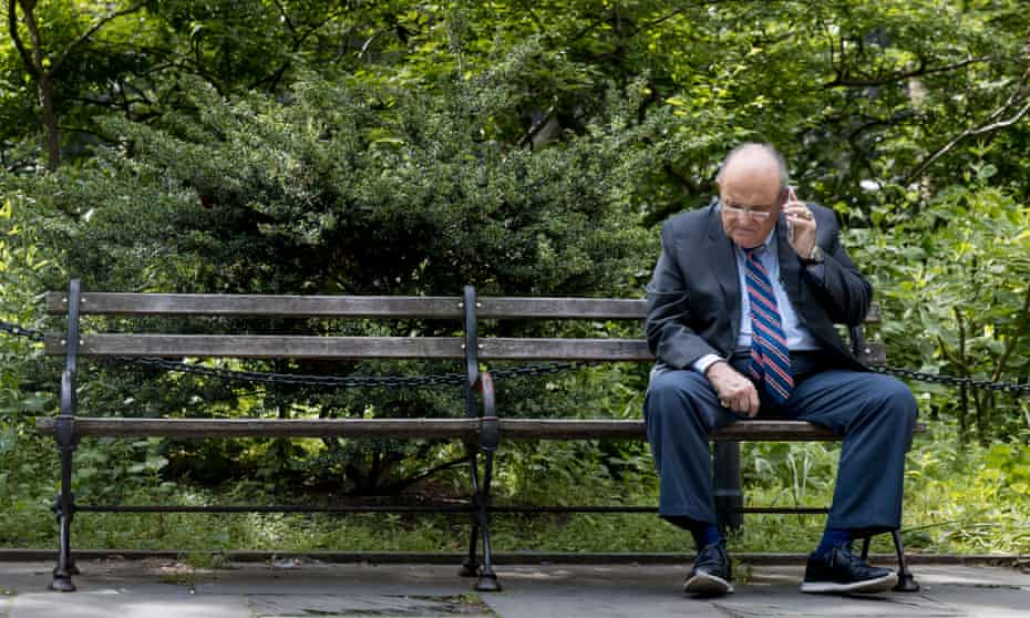 Rudy Giuliani sitting on a park bench
