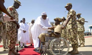 President Buhari presents Lance Corporal Kenneth Kulugh with the Purple Heart medal