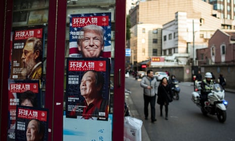 An advertisement for a magazine featuring US President-elect Donald Trump on the cover at a news stand in Shanghai.
