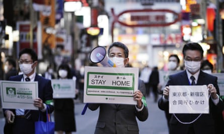 Staff of the Tokyo’s city authority urge people to go home from the Kabukicho district in April.