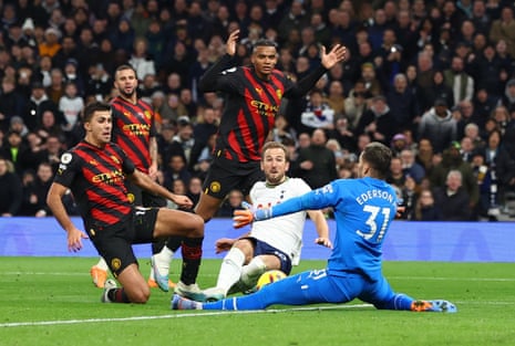Manchester City's Ederson, Rodri and Manuel Akanji try to stop Tottenham Hotspur's Harry Kane.