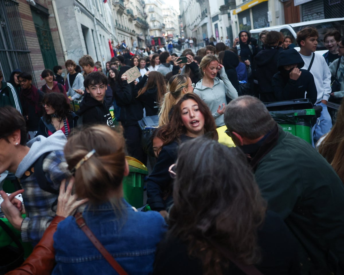 A French high school student confronts people who want to prevent her from building a barricade, outside the Lycee Lamartine high school in Paris.