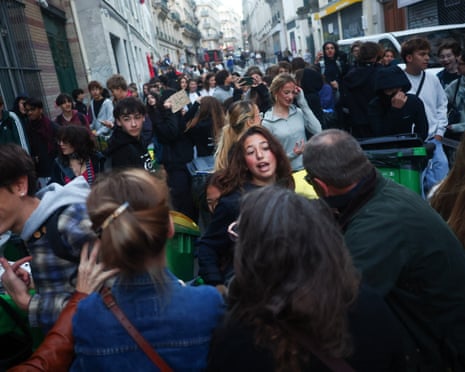A French high school student confronts people who want to prevent her from building a barricade, outside the Lycee Lamartine high school in Paris.