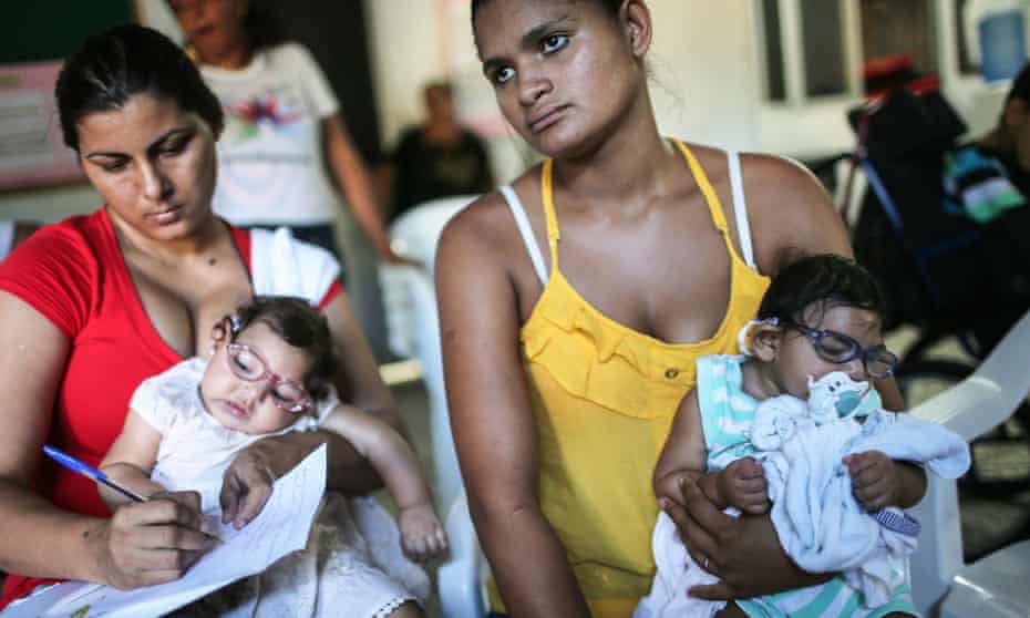 Infants born with microcephaly are held by mothers at a meeting for mothers of children with special needs on 2 June 2016 in Recife, Brazil.