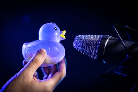 Jojo holds up a rubber duck to one of his microphones