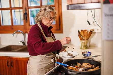 A woman cooking on a stove.