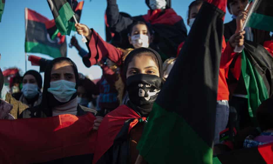 People wave flags and chant slogans during a gathering to commemorate the tenth anniversary of the Arab Spring in Martyrs Square on 17 February, 2021 in Tripoli, Libya. 