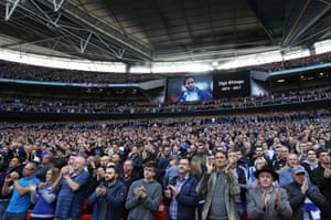 An image of Ugo Ehiogu is displayed on the big screen as fans applaud during The FA Cup semi-final between Chelsea and Tottenham Hotspur at Wembley.