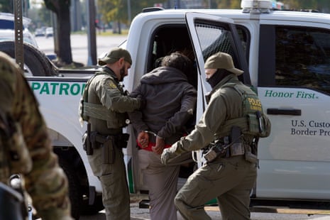 Border patrol agents detain a man on the street in New Orleans, Louisiana.