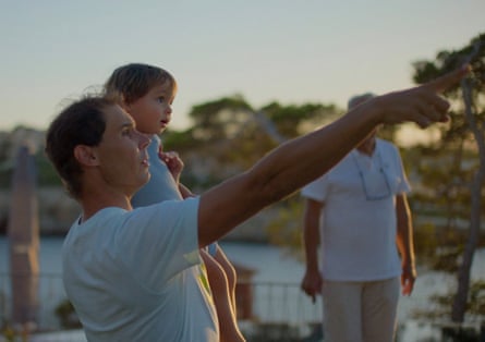 A man outside holding a young girl and pointing