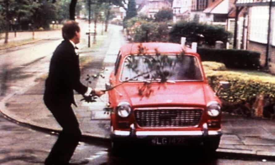 An enraged Basil Fawlty attacks his car with a branch.