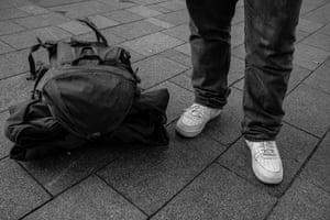 A homeless man wears a pair of trainers given to him by the charity Resole who provide the homeless and at risk youths with footwear, encouraging healthier lifestyles and helping prevent disease