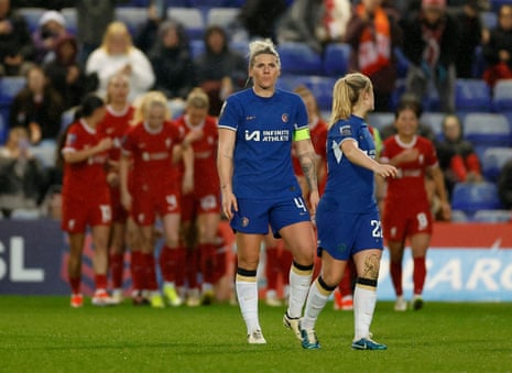 Chelsea’s Millie Bright looks dejected as Liverpool’s Sophie Roman Haug celebrates scoring their equaliser with teammates.