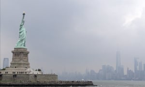 The Statue of Liberty, with New York City in the background on a stormy day earlier this month. Light conditions in the harbor today not dissimilar!
