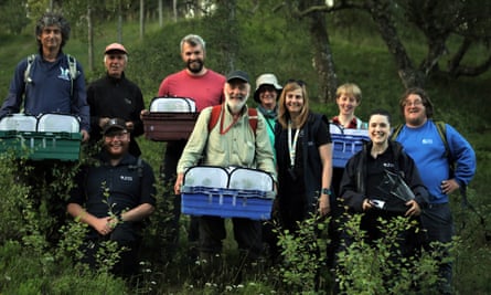 Members of the dark bordered beauty steering group participate in the release of 160 dark bordered beauty caterpillars in the Cairngorms.