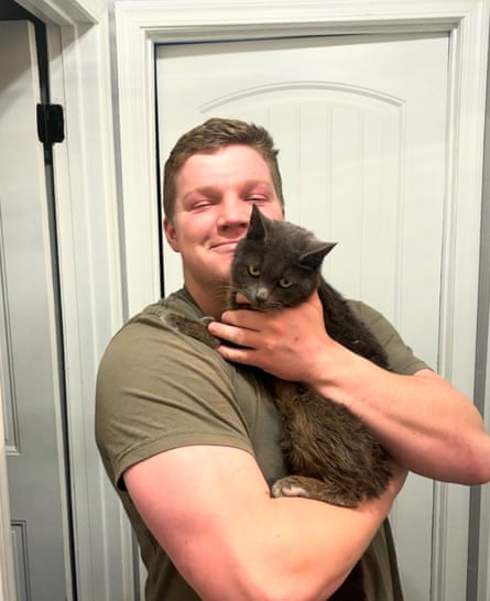 man holds cat